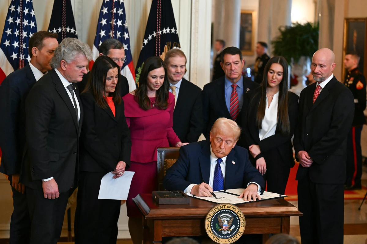 President Trump signs the Laken Riley Act in the East Room of the White House on Jan. 29.