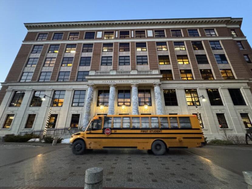 A school bus drives by the Alaska State Capitol on Jan. 21, 2026.