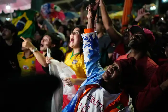 Supporters of President Luiz Inácio Lula da Silva cheer as the results of Brazil