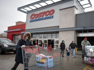 Customers walk in the parking lot outside a Costco store in Chicago on Dec. 2, 2025.