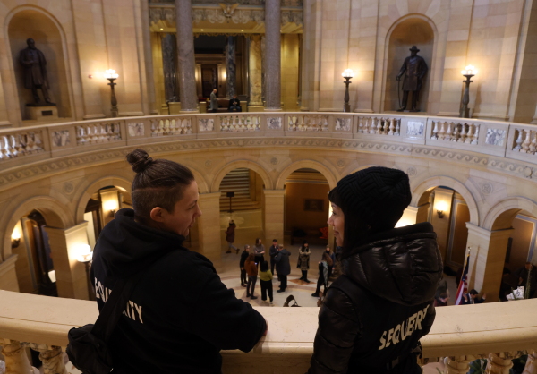 Sam Koshiol-Wright, left, and Aleksi Brown talk after a press conference the group Sequeerity monitored for any confrontations at the Minnesota State Capitol in Saint Paul, Minn., Dec. 3.