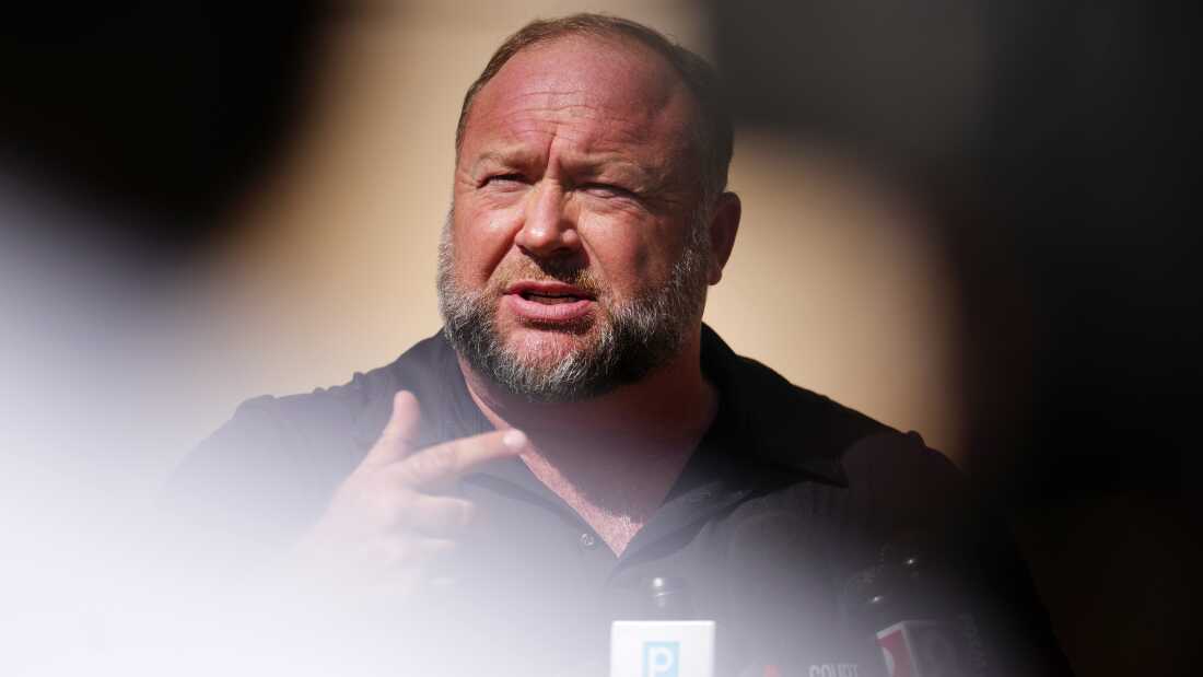 InfoWars founder Alex Jones speaks to the media outside Waterbury Superior Court during his trial on September 21, 2022 in Waterbury, Connecticut. Jones is being sued by several victims' families for causing emotional and psychological harm after they lost their children in the Sandy Hook massacre.