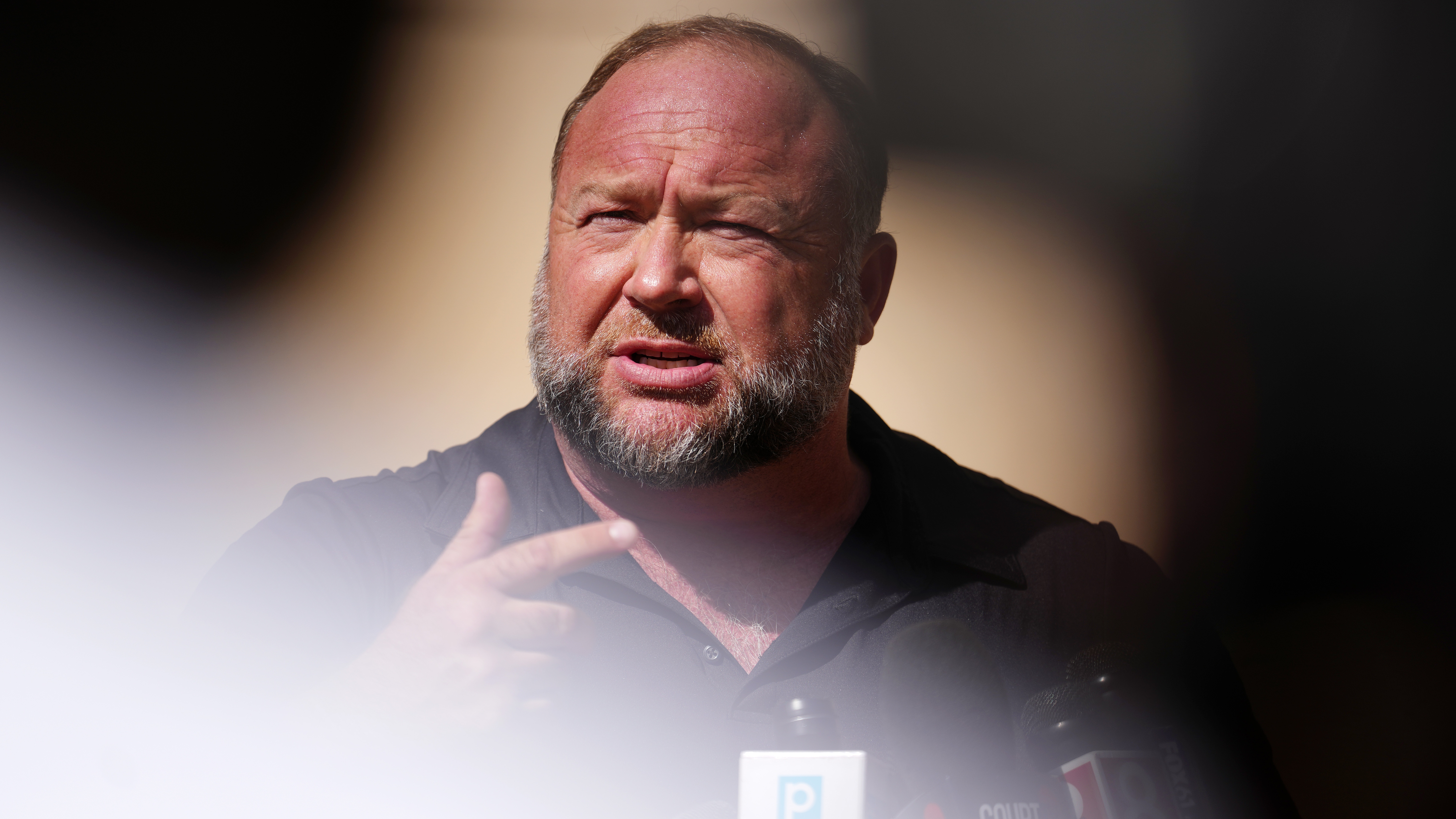 Infowars founder Alex Jones speaks to the media outside Waterbury Superior Court in Waterbury, Conn., on Sept. 21, 2022. Several victims