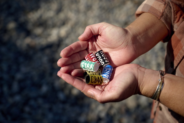 Jessie Beck holds tags used to keep track of albatrosses she studied before funding was cut by the federal government.