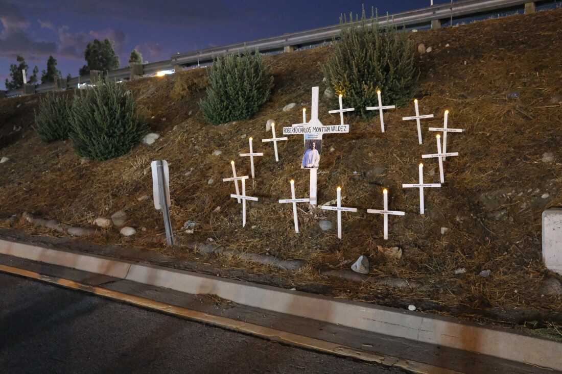 A monument to Carlos Roberto Montoya Valdez (his first and second names are mistakenly placed on the cross). Activists said Montoya died while running across the freeway to avoid an ICE raid of day laborers at the Home Depot parking lot across the street. Los Jornaleros – many of the band members themselves day laborers – performed at a memorial concert for him.