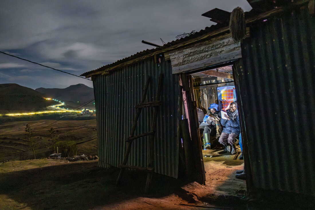 Students in class at a rudimentary night school in the village of Ha Ntsokoane in Thaba Tseka, Lesotho. Many of the students are shepherds who missed out on formal schooling during childhood. The school operates on a shoestring budget and lacks electricity, so students study by the light of their phones.