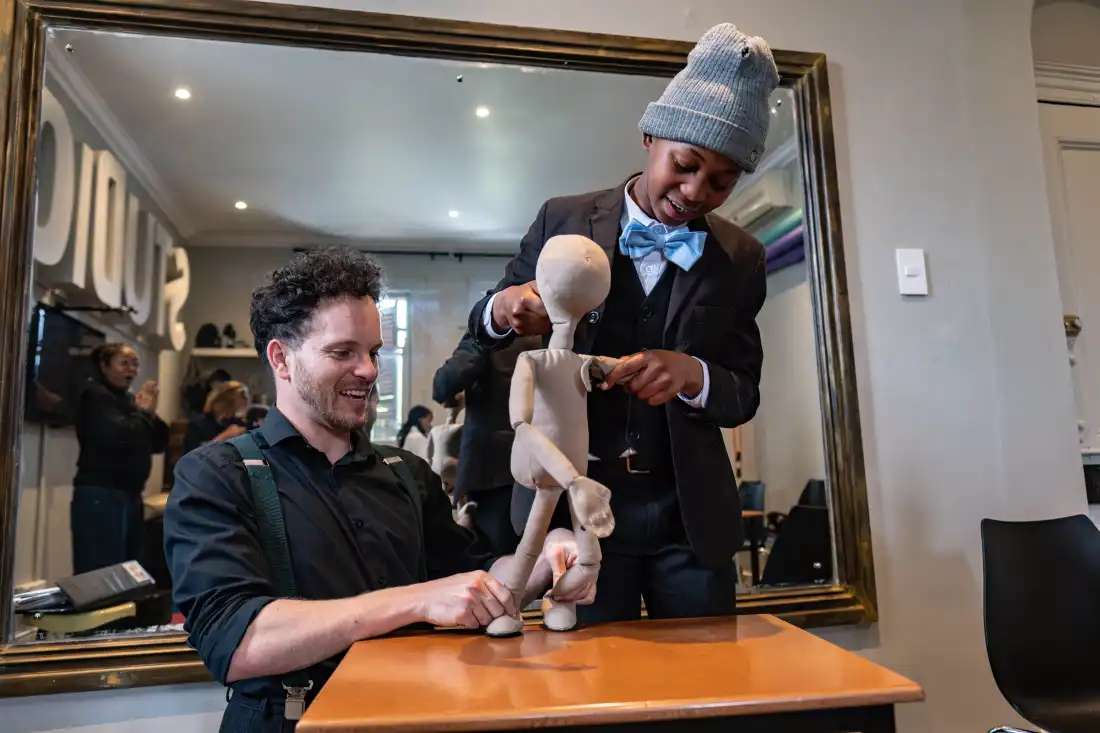 12-year-old Okuhle Ntshutshe takes part in a puppetry excercise with teacher Jesse Brooks during class at the College of Magic in Cape Town, South Africa.