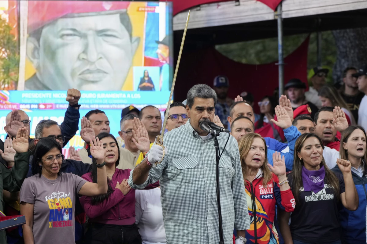 Venezuelan President Nicolás Maduro brandishes a sword as his new Cabinet takes the oath of office, at the presidential palace in Caracas, Venezuela, Aug. 28.