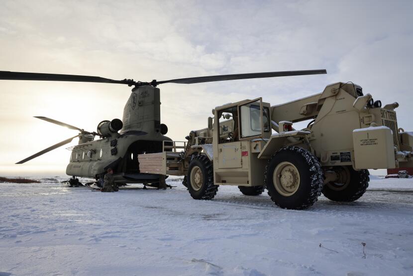Alaska Organized Militia members load building supplies onto an Alaska National Guard Chinook helicopter in Bethel on Nov. 3, 2025.