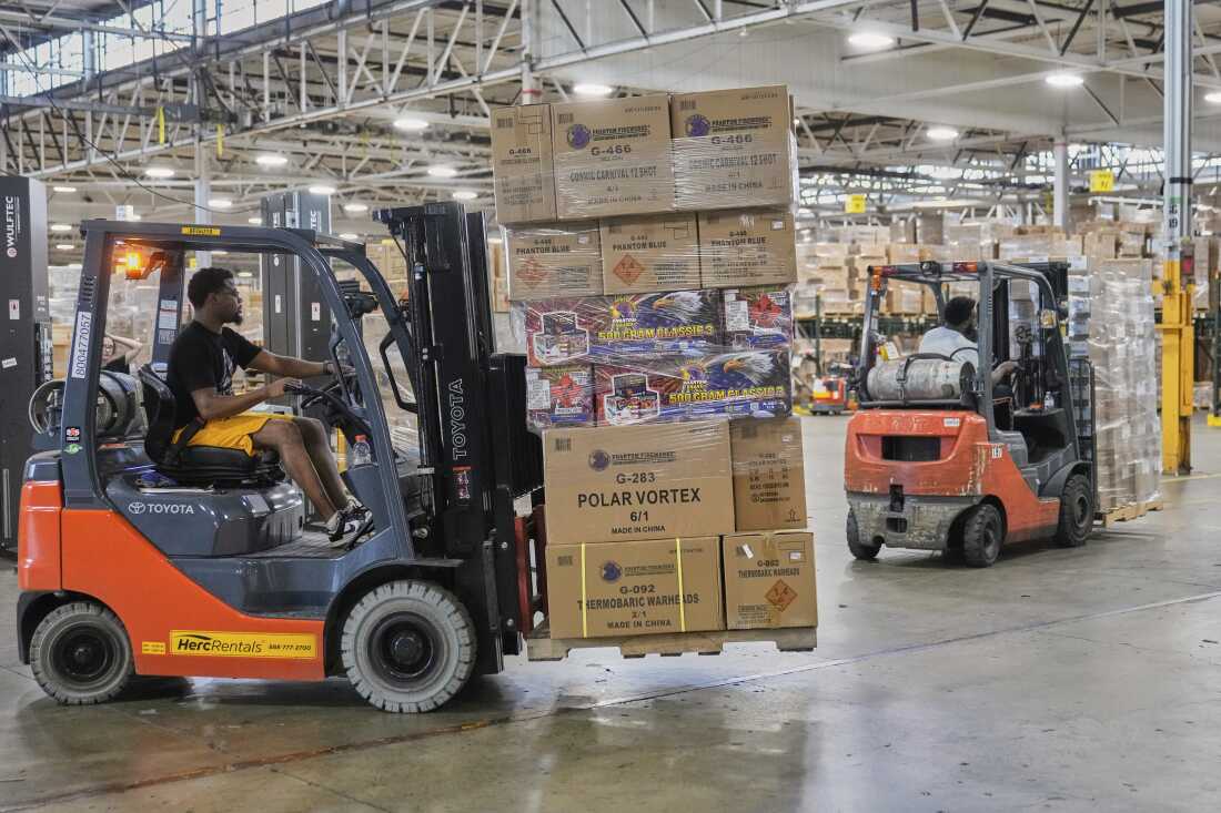 A worker carries a shipment of fireworks on a forklift at the Phantom Fireworks warehouse in Warren, Ohio.