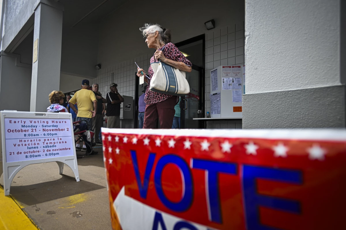 A person leaves an early voting site after casting a ballot on Oct. 21 in Deland, Fla. Florida is one of three states that recently sued the Biden administration over citizenship checks of voters.