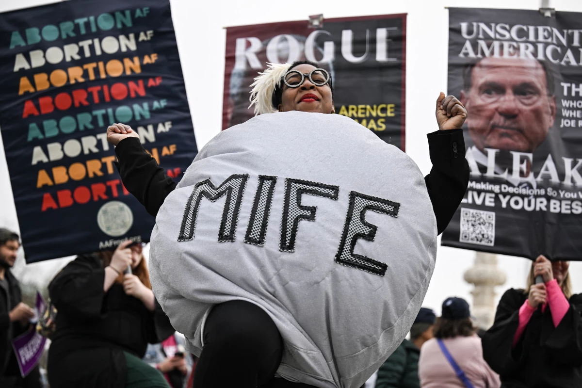 A woman dressed as a mifepristone pill is at rally outside the US Supreme Court on April 2, 2025.