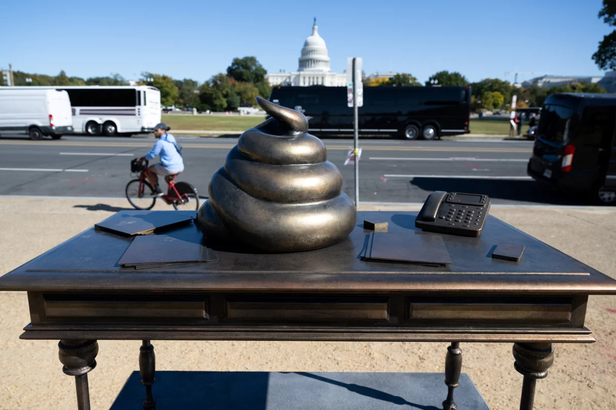 A bronze art installation depicting a pile of feces on former House Speaker Nancy Pelosi's desk appeared on the National Mall near the U.S. Capitol on Thursday, surprising and amusing passersby.