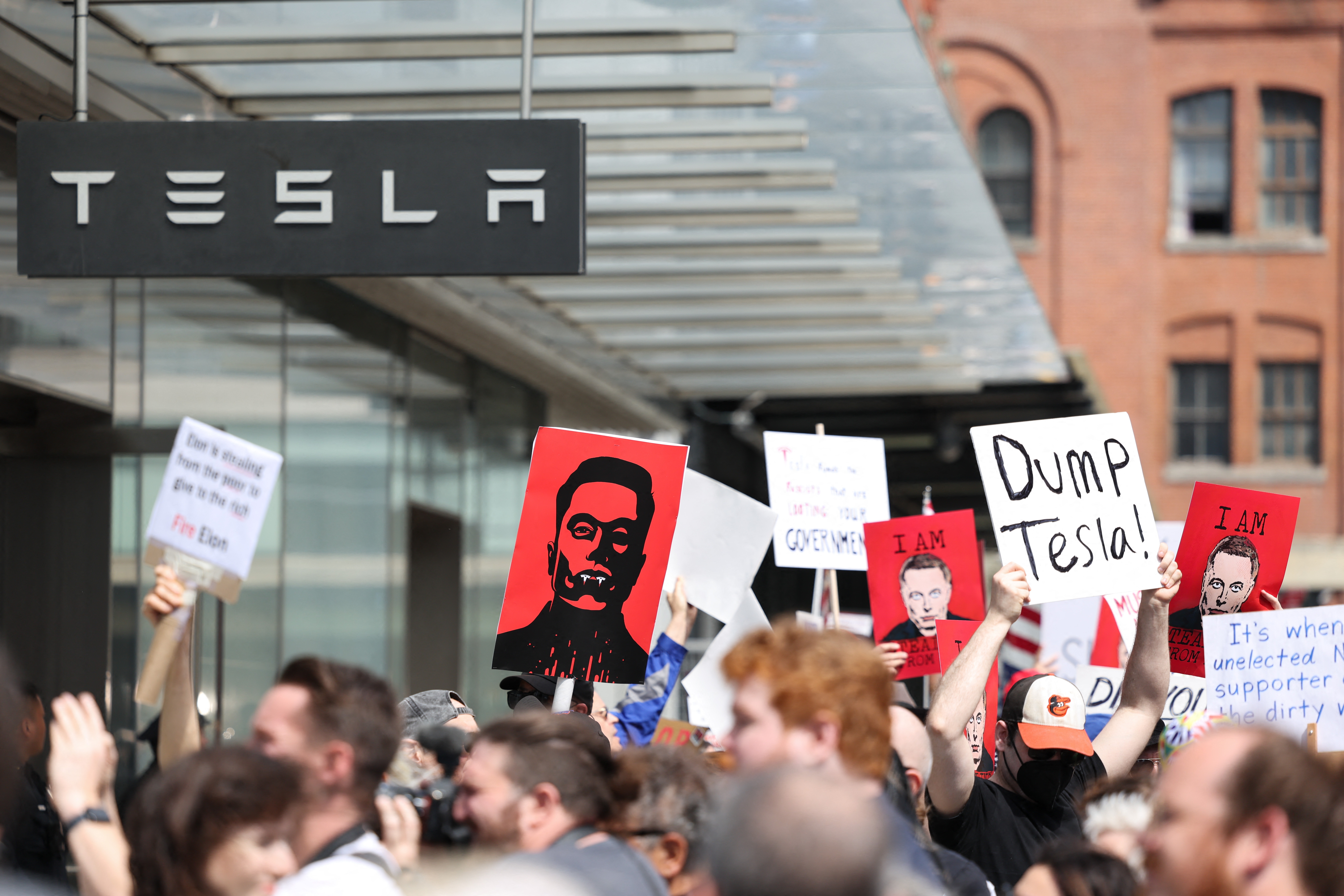 Demonstrators rally against Tesla CEO Elon Musk during a "Tesla Takedown" protest outside a Tesla store in New York City on Saturday.