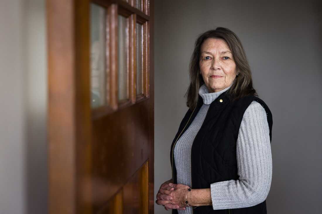 Terri Mabe is shown standing near a church door.