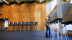 A voter casts her ballot in Colorado's primary election at Denver's Central Library on June 30.