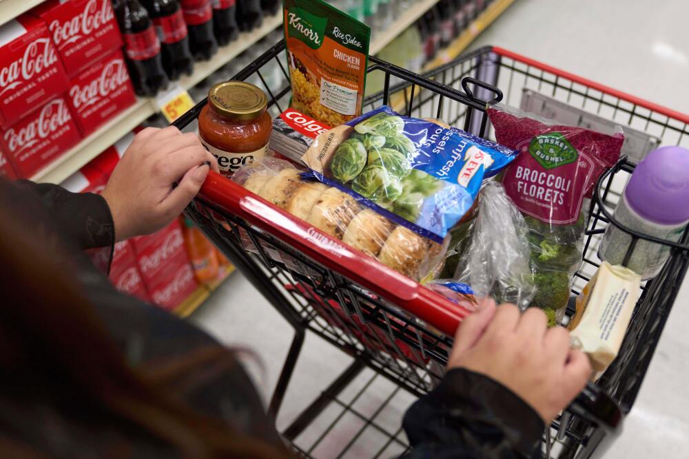 A California SNAP benefits shopper pushes a cart through a supermarket. (AP)