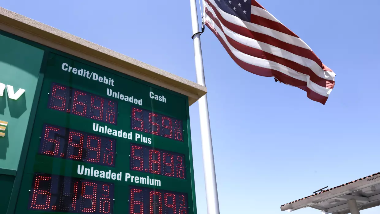 An American flag flies above a sign displaying gas prices at a gas station in Arcadia, Calif., on May 11.