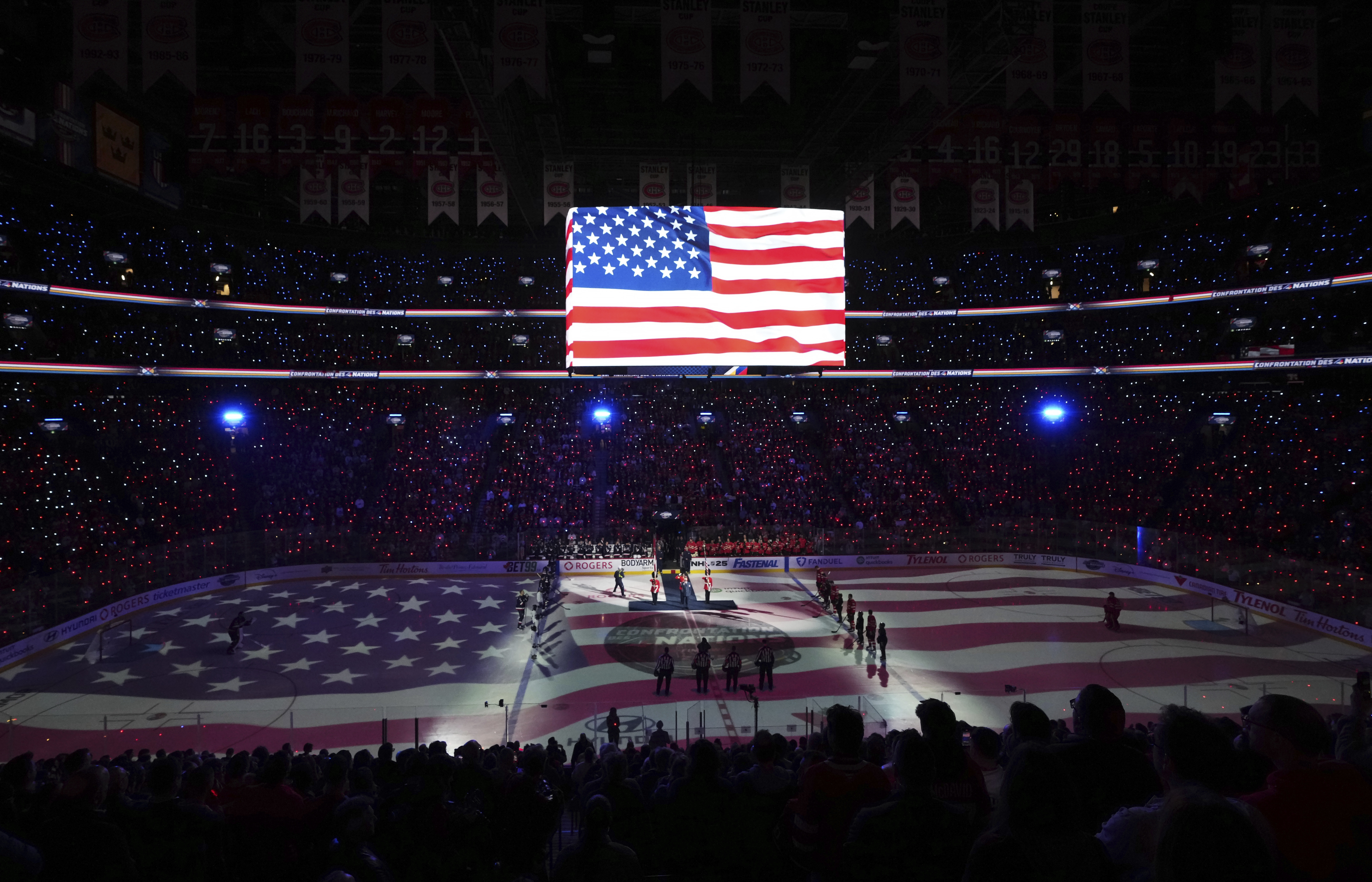 Players and fans stand for the U.S. national anthem prior to the first period of 4 Nations Face-Off hockey game between Canada and the United States in Montreal on Saturday, Feb. 15, 2025.