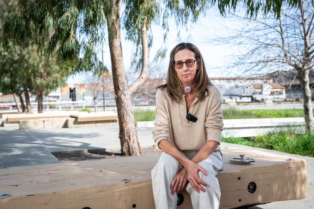 Sonya Sotinksy sits at Crane Cove Park in San Francisco on March 25, 2025. Sotinsky was diagnosed with stage 4 tongue cancer and underwent surgery to remove her tongue, larynx, and other structures. She then worked with researchers to create an AI-generated voice using past recordings of her speech.