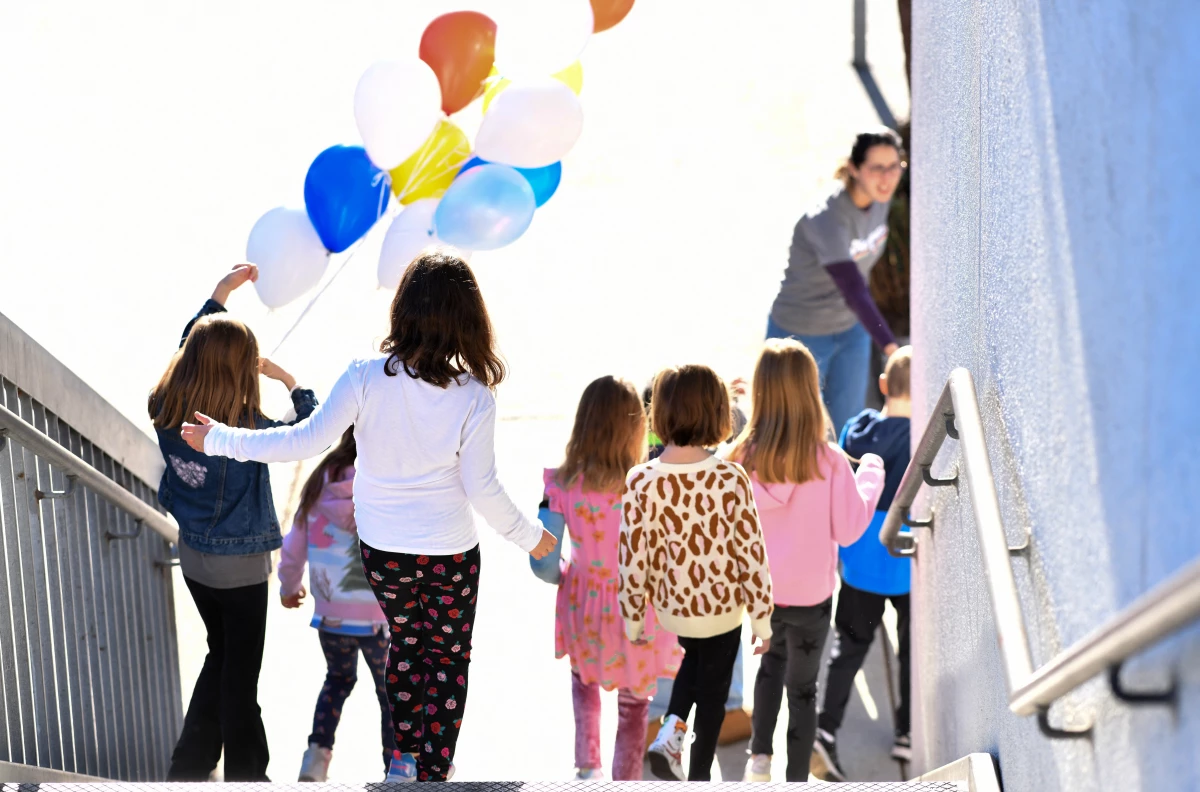 A teacher gives a tour of Nora Sterry Elementary School to students in Los Angeles in January. California is one of 24 states suing the Trump administration over frozen education grant funding.
