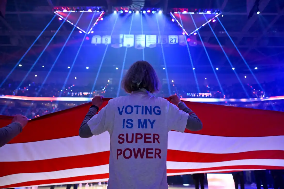 A member of the League of Women Voters of Greater Cleveland helps hold the flag during the national anthem before a basketball game on Oct. 26, 2026 in Cleveland, Ohio.