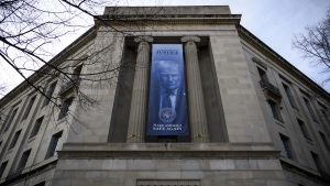A banner of an image of President Trump is displayed on the facade of the U.S. Department of Justice headquarters in Washington, D.C., in February 2026.