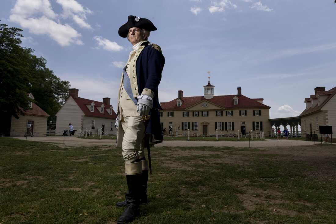 Doug Thomas, a first person interpreter, poses for a portraits as General George Washington in front of the Mount Vernon mansion in Virginia.