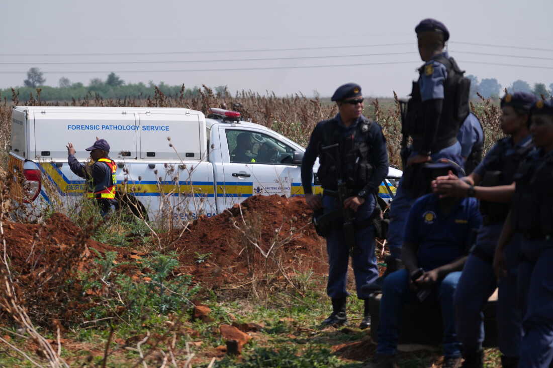Forensic investigators work at the site where the body of a woman was discovered on the outskirts of Johannesburg, South Africa, Thursday, Sept. 17, 2026.