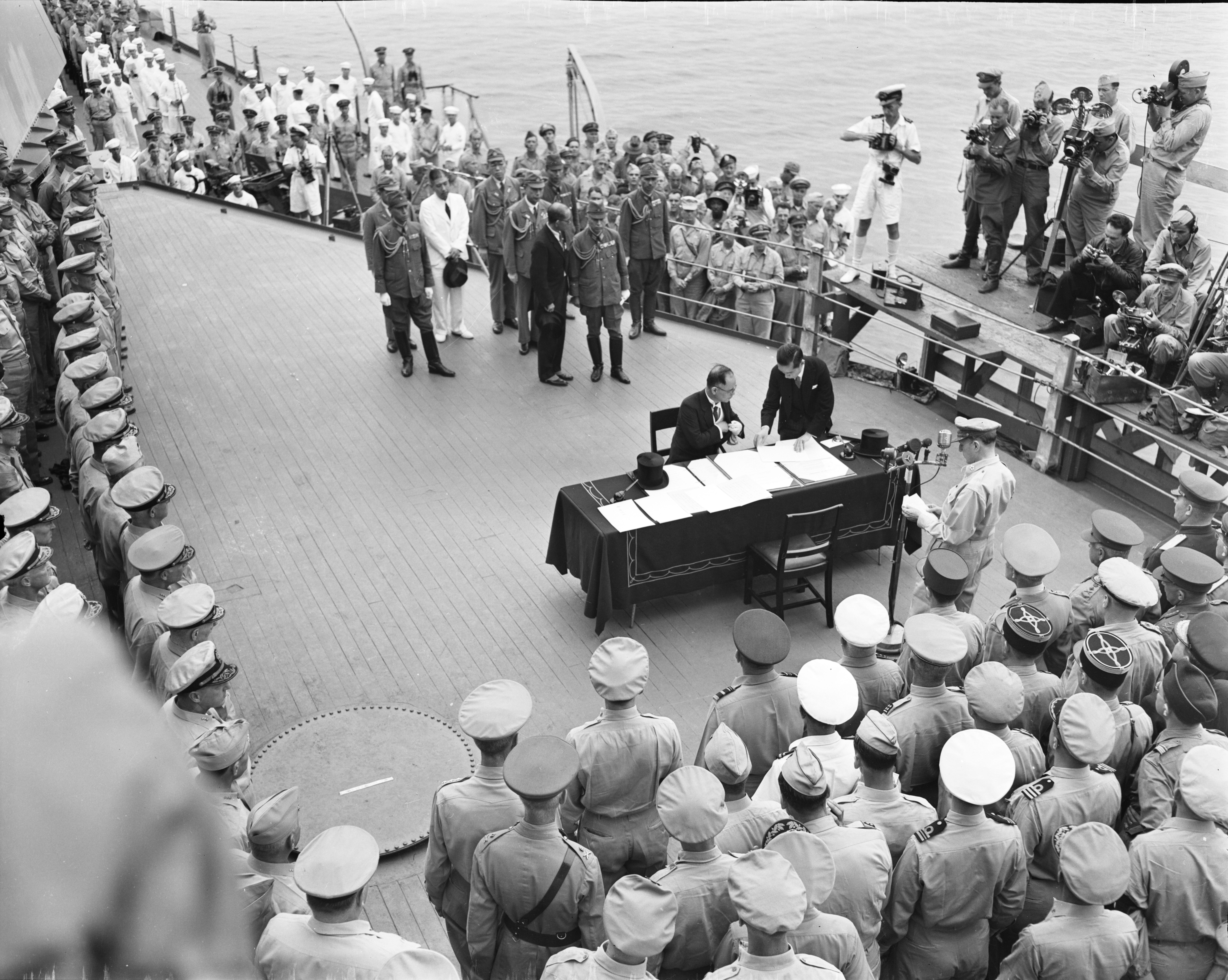 Japanese foreign minister Namoru Shigemitsu signs surrender terms as Allied officers look on Sept. 2, 1945 on USS Missouri moored in Tokyo Bay.