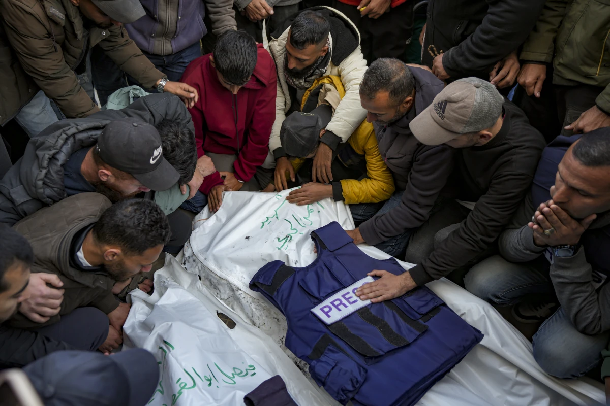 Relatives and friends mourn over the bodies of five Palestinian journalists who were killed by an Israeli airstrike in Gaza City at the Al-Aqsa Hospital in Deir al-Balah, on Thursday.