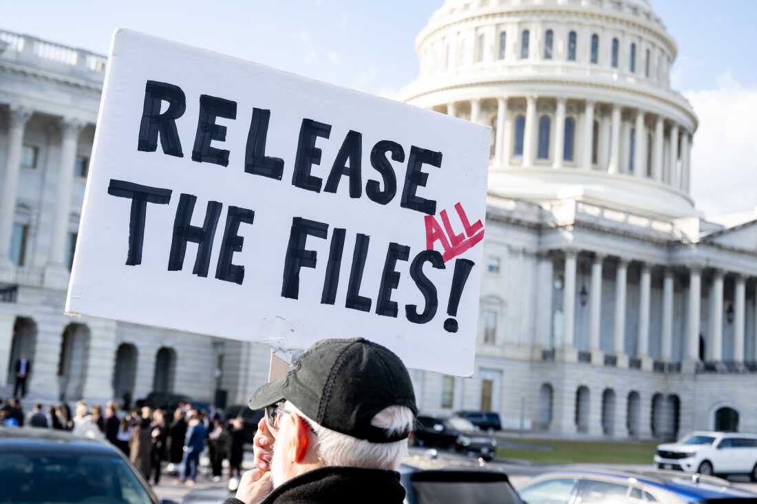A protester holds a sign related to the release of the Jeffrey Epstein case files outside the U.S. Capitol on Nov. 12, 2025.