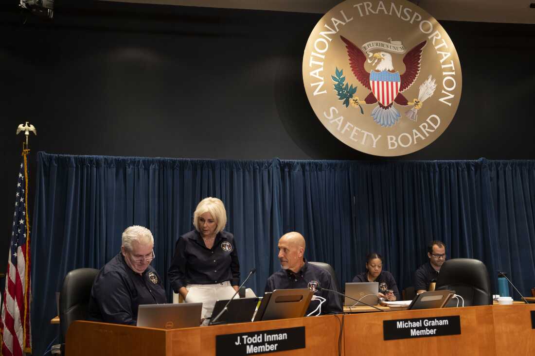 Members of the National Transportation Safety Board speak before an investigative hearing about the January midair collision between an American Airlines regional jet and a U.S. Army Black Hawk helicopter near Ronald Reagan Washington National Airport.