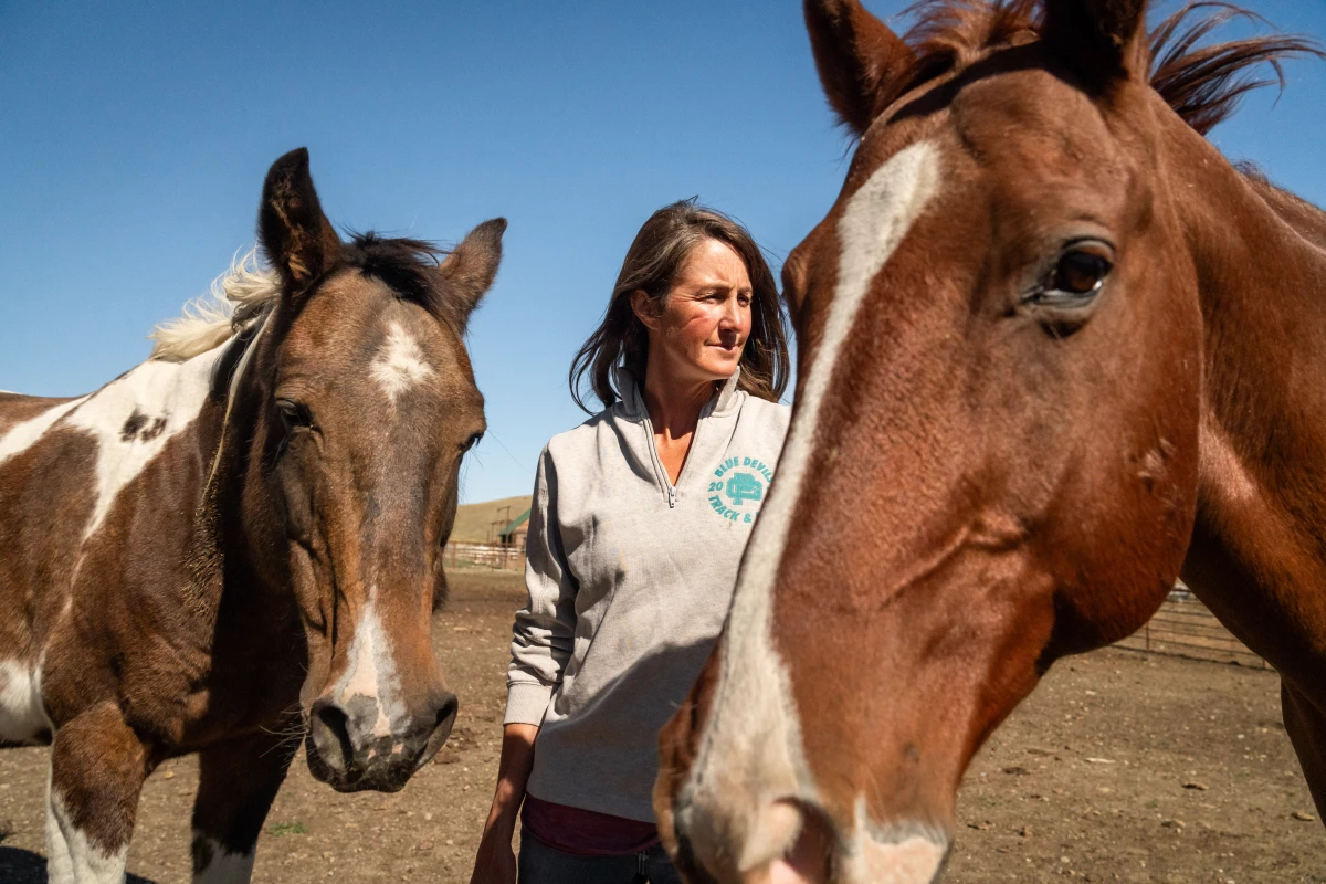 Hilary Zaranek with her horses at one of her family's ranches near Melville, Mont.