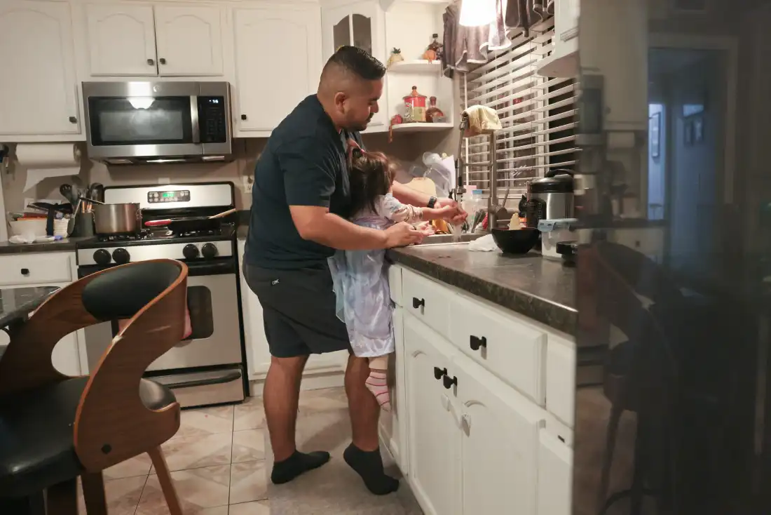 Karlo Campana washes Giselle’s hands after dinner on October 12 at home inSanta Ana, Calif.
