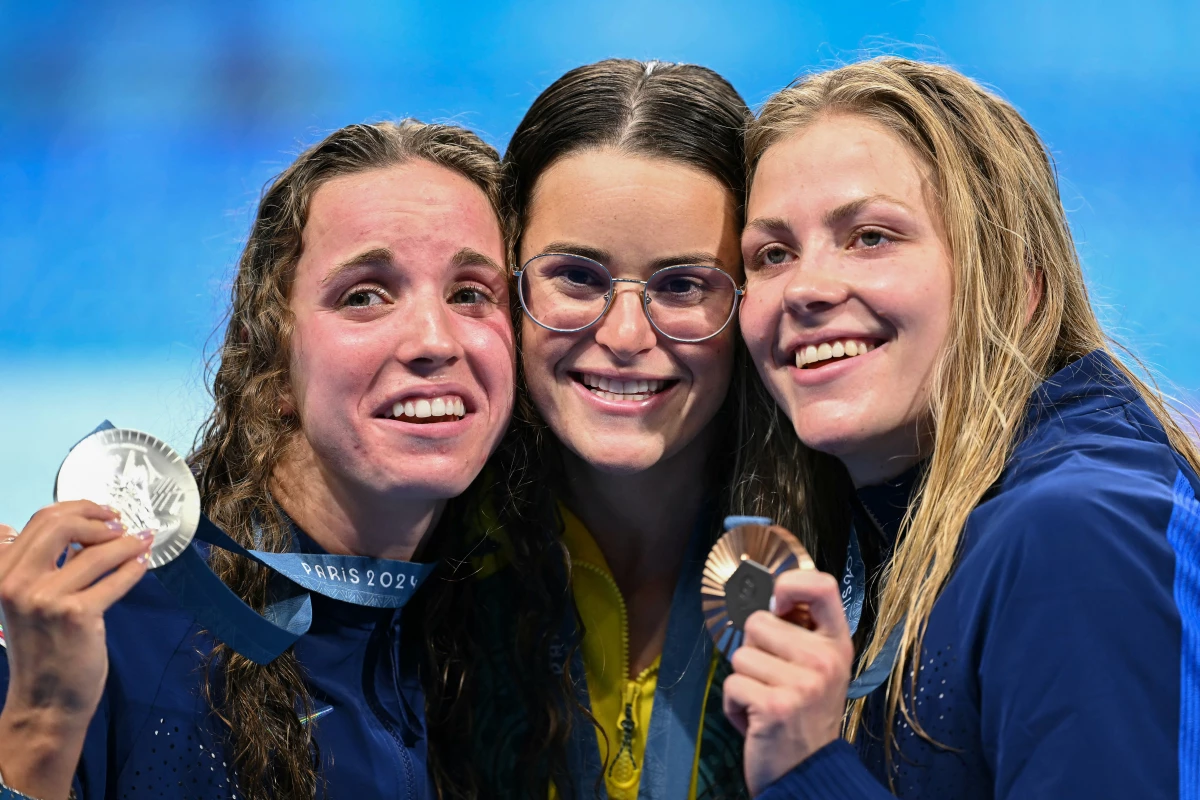 From left, U.S. silver medalist Regan Smith, Australian gold medalist Kaylee McKeown and U.S. bronze medalist Katharine Berkoff pose with their medals following the women's 100-meter backstroke swimming event during the Paris 2024 Olympic Games on Tuesday. Berkoff's bronze was not only the 3,000th medal for Team USA, but also the 600th Olympic medal earned by a USA swimming athlete.
