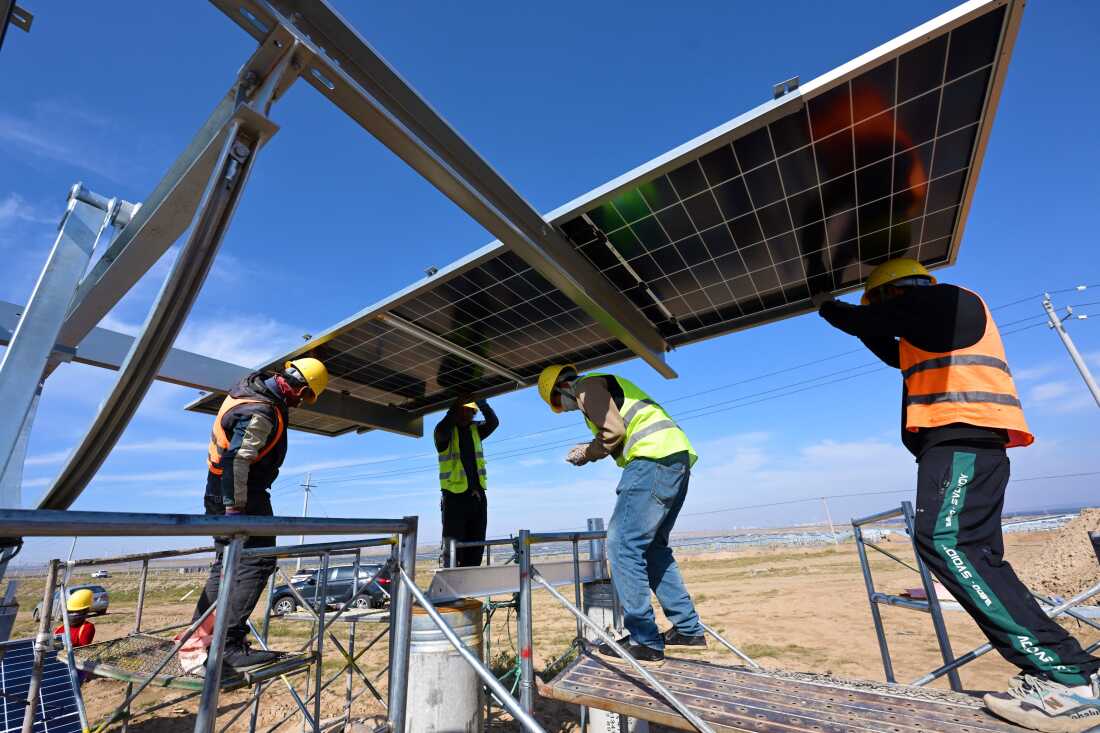 Workers install solar panels in China's northern Ningxia region.