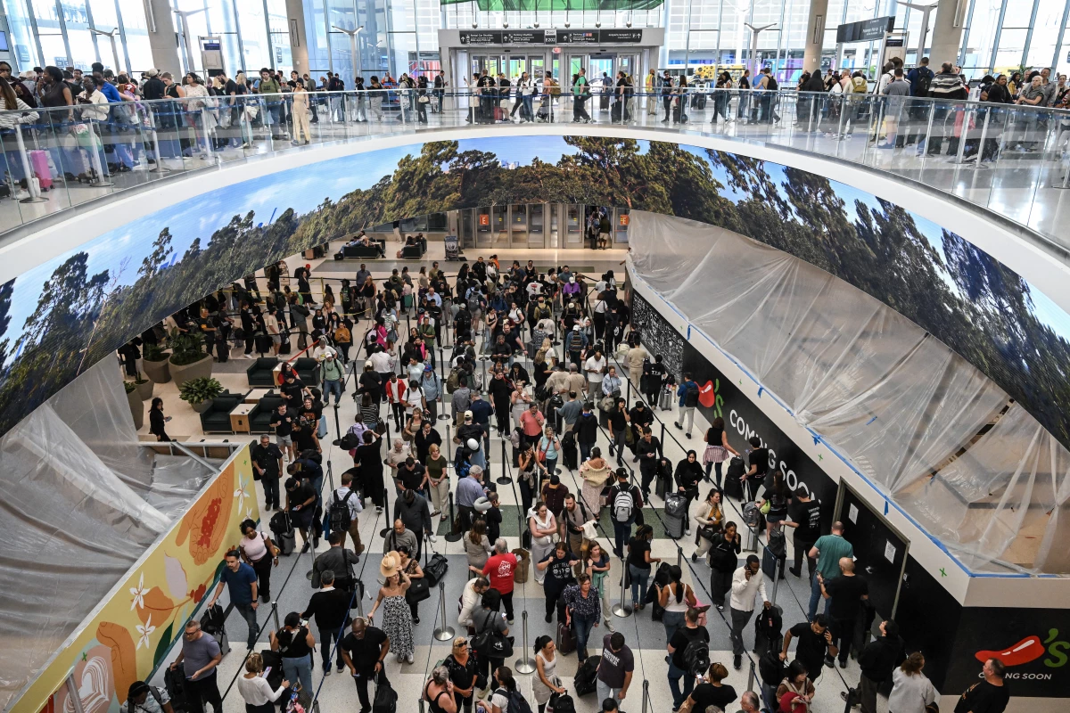 Travelers wait in long security lines at George Bush Intercontinental Airport in Houston on Monday.
