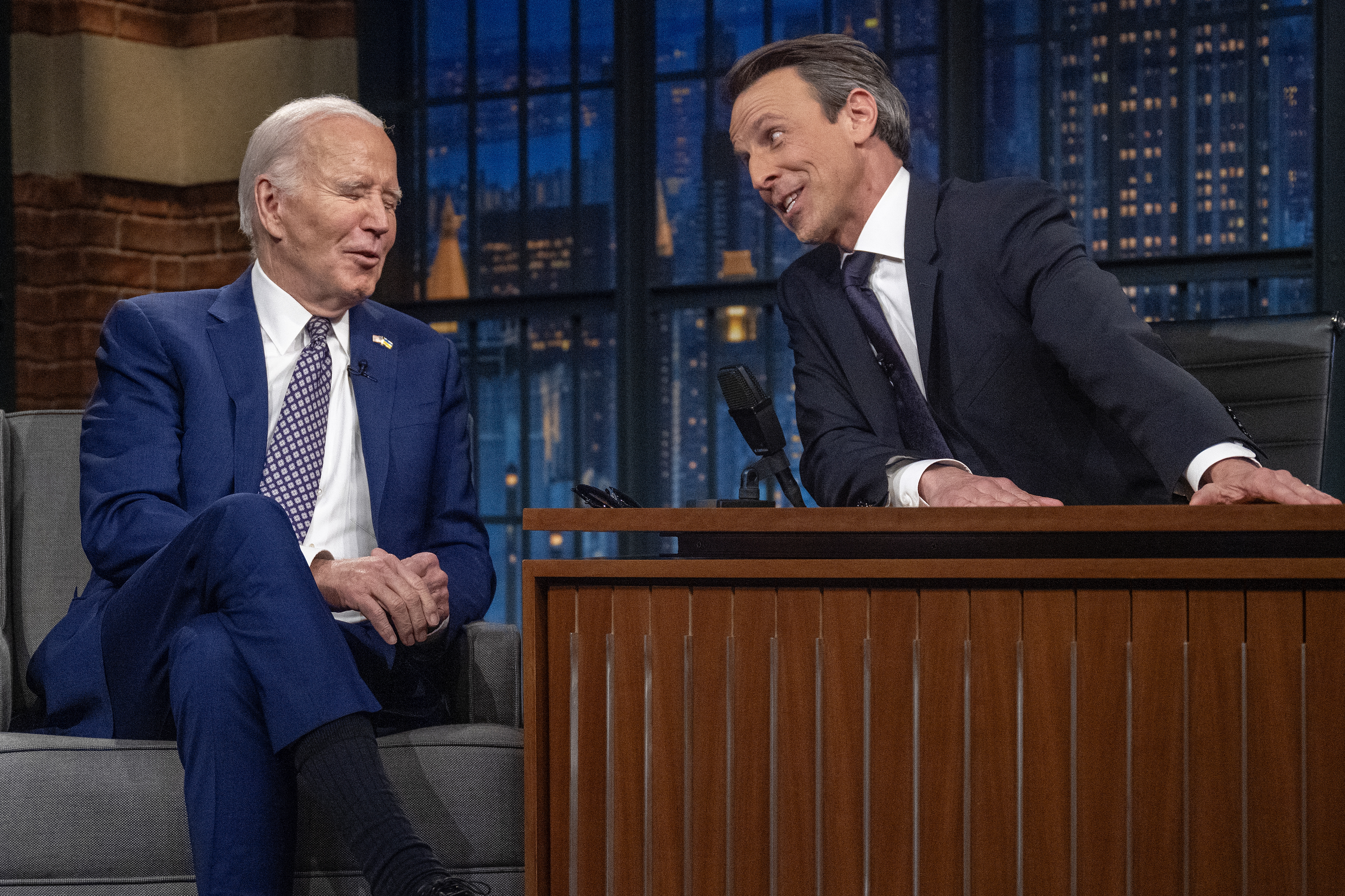 Seth Meyers talks to President Joe Biden during a taping of "Late Night with Seth Meyers" in New York in February.