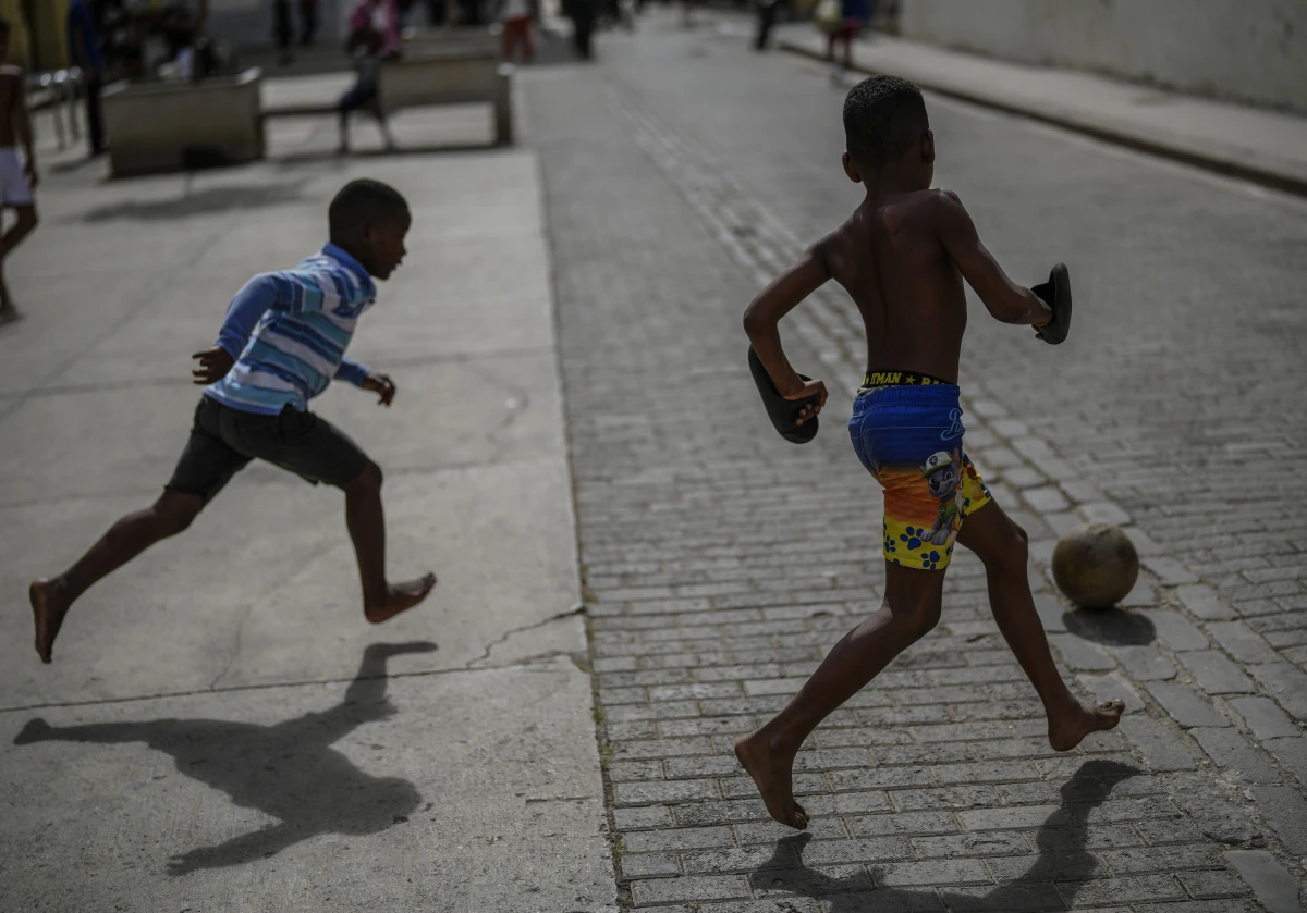 Children kick a ball around during a power outage in Havana, Cuba, on Wednesday.