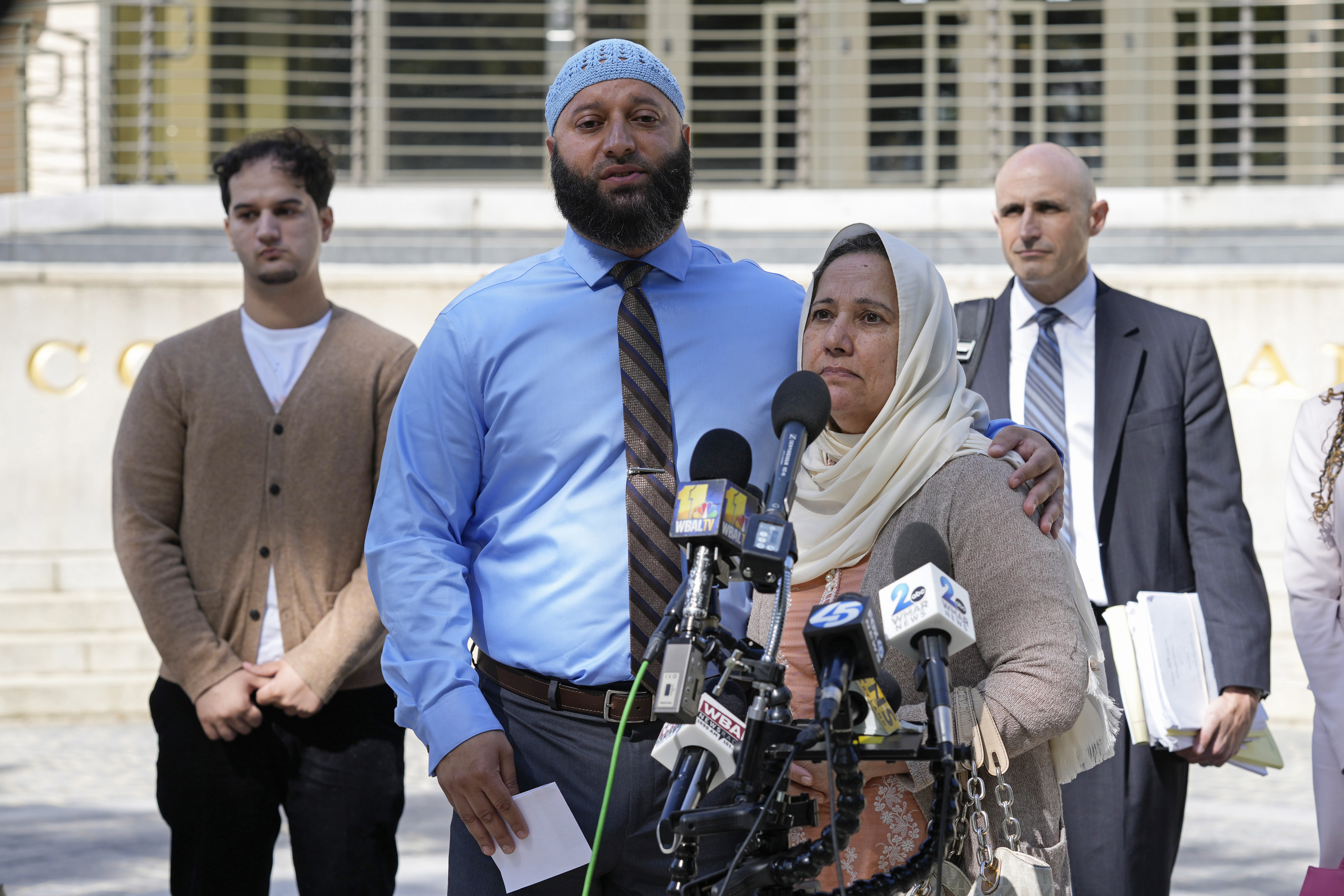 Adnan Syed, standing with his mother Shamim Rahman, talks with reporters outside Maryland