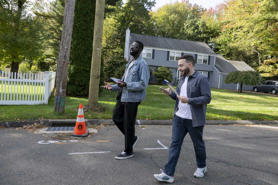 Olaleye Onikuyide (left) and his campaign manager, Karo Shakhnazarov, walk down a neighborhood street as they canvass in West Hartford, Connecticut, on October 10, 2026.