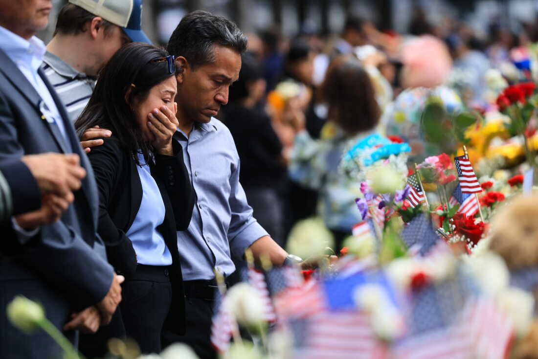 People pause as they stand at the memorial during a ceremony commemorating the 25th anniversary of the September 11th terrorist attacks on the World Trade Center at the National 9/11 Memorial & Museum on September 11, 2026 in New York City.
