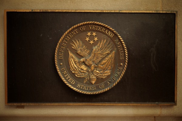 A plaque depicts the Department of Veterans Affairs' seal with an eagle clutching two flags in its talons and five stars above the eagle.