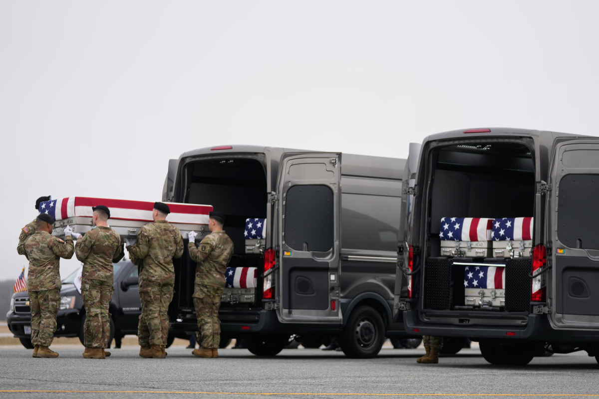 March 7: An Army team at Dover Air Force Base moves a flag-draped transfer case from a transport van containing the remains of U.S. Army Reserve soldiers Maj. Jeffrey O'Brien, of Indianola, Iowa, Capt. Cody Khork, of Winter Haven, Fla., and Chief Warrant Officer 3 Robert Marzan, of Sacramento, Calif. The three were killed in a drone strike at a command center in Kuwait.