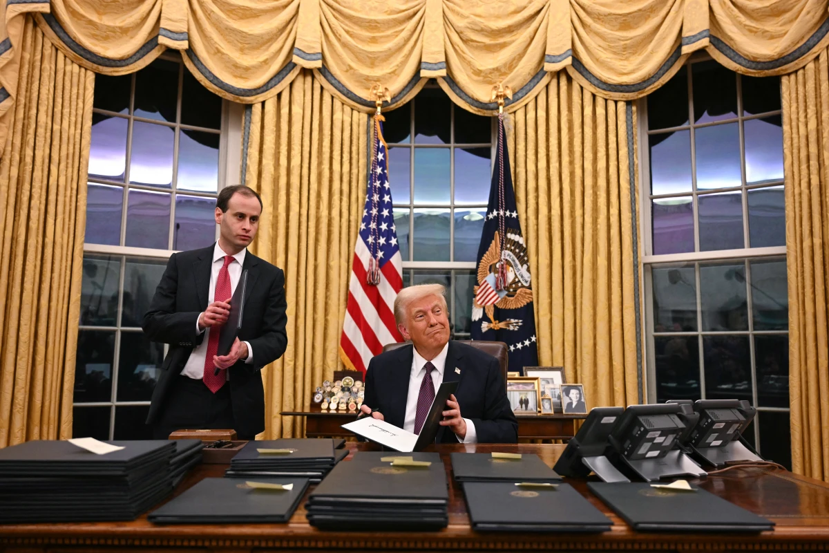 President Trump signs executive actions at the White House after his inauguration Monday. Among those orders is one labeling Mexican drug cartels terrorist organizations.