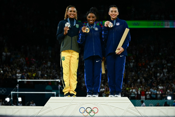 Silver medalist Rebeca Andrade of Brazil (L), gold medal winner Simone Biles (C) and bronze-medalist Sunisa Lee (R) of the U.S. pose during the podium ceremony after the gymnastics women's all around final at the Paris Olympic on Thursday.