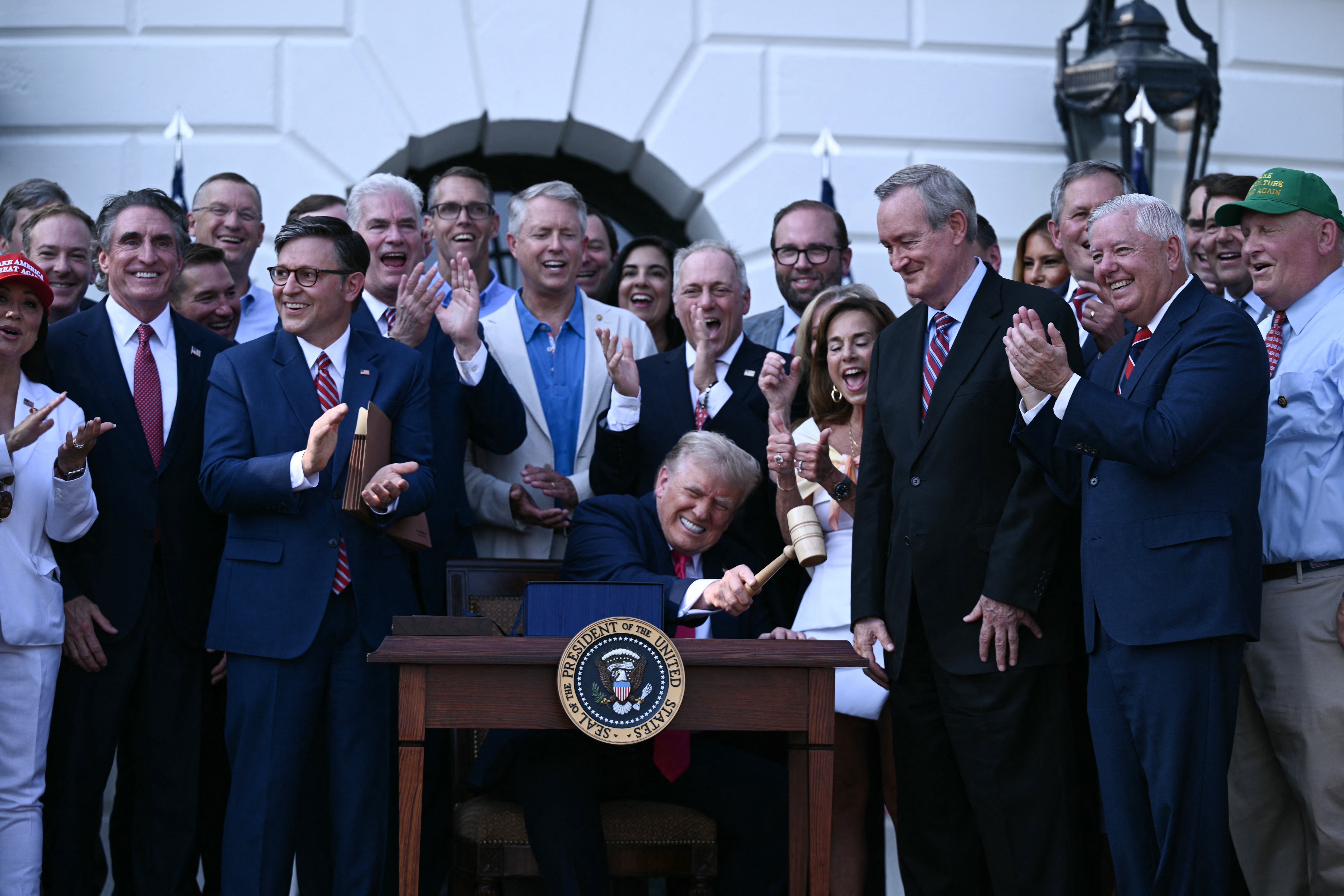 President Trump bangs a gavel after signing the One Big Beautiful Bill Act at the White House on July 4.