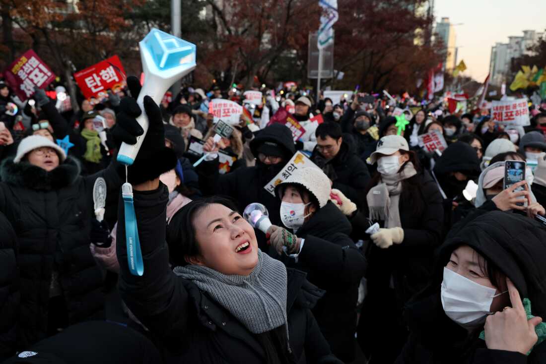 Protesters celebrate as the parliament votes to impeach South Korean president Yoon Suk Yeol over his decision to impose a martial law, in front of National Assembly on Saturday, in Seoul.