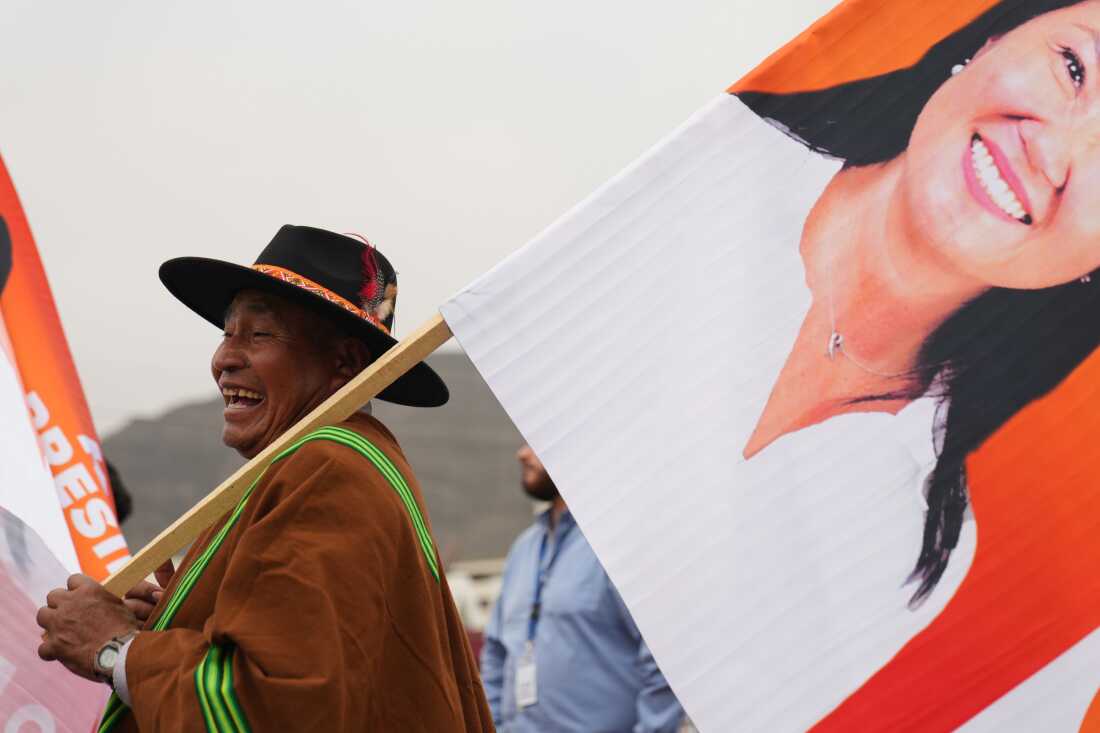 A supporters hols a banner of presidential candidate Keiko Fujimori during her closing campaign rally in Lima, Peru, Thursday.